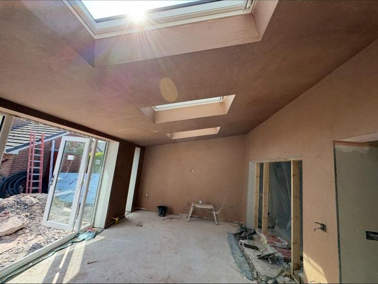 Full room re-plastered including new ceiling — flawless smooth finish throughout