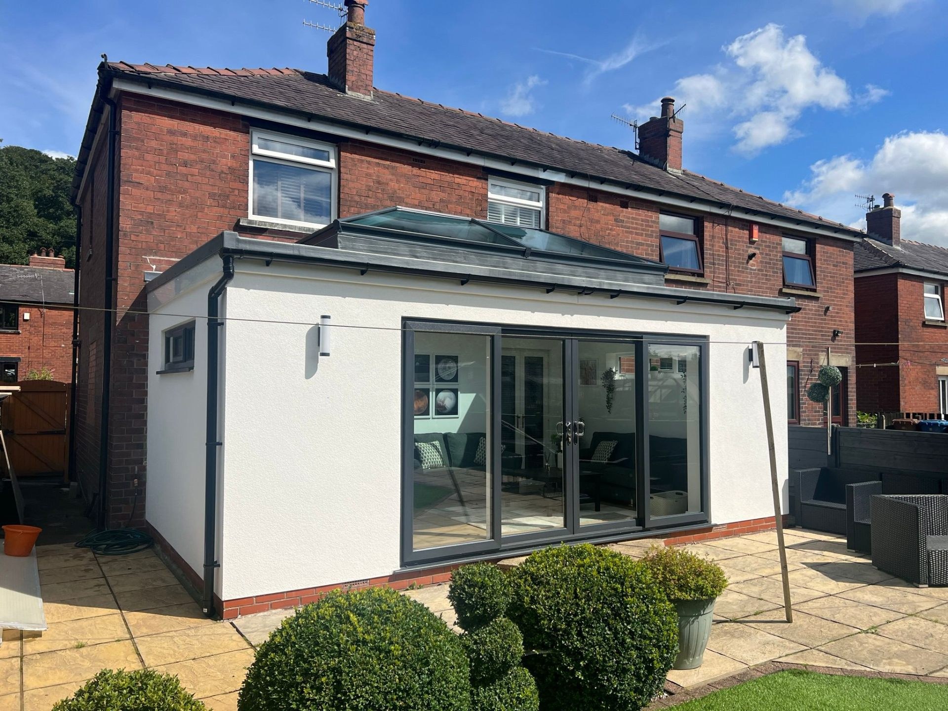 Modern UK rendered extension finished in K Rend silicone render combined with contrasting black timber cladding